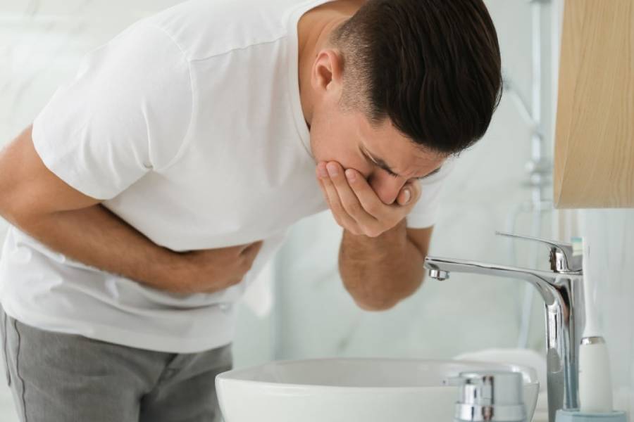 Man experiencing vomiting due to food poisoning – Food Poisoning Treatment in Coimbatore by Dr. A. Murali
